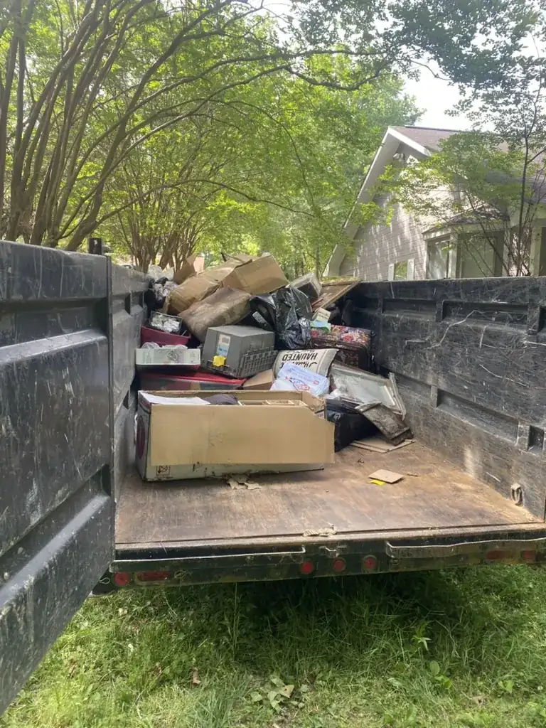 Toss It dump trailer loaded with household junk and debris from a real cleanout project in Auburn, Alabama